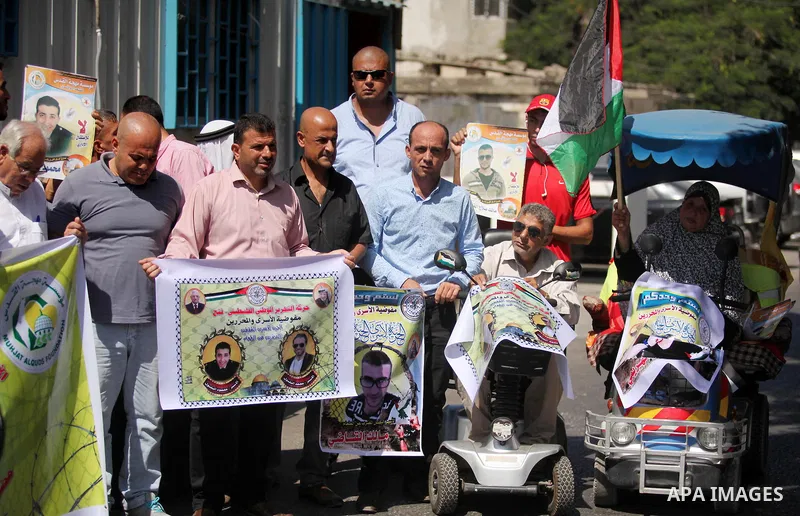 Palestinians hold banners during a protest to show solidarity with Palestinian prisoners on hunger strike in Israeli Jails, in front of the high commissioner for human rights headquarters in Gaza City, on Sept. 04, 2016....