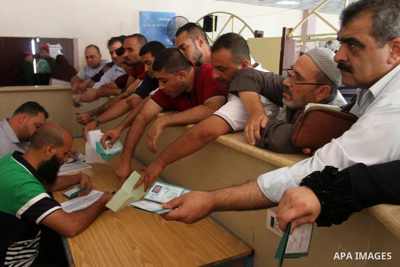 Palestinians wait for travel permits to cross into Egypt through the Rafah border crossing, on September 4, 2016 in the southern Gaza Strip. Egyptian authorities temporarily reopened it both directions for two days in Ga...