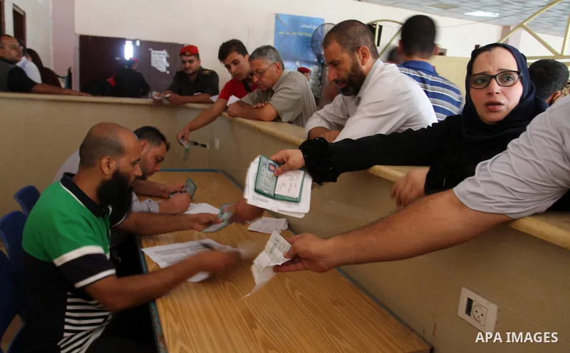 Palestinians wait for travel permits to cross into Egypt through the Rafah border crossing, on September 4, 2016 in the southern Gaza Strip. Egyptian authorities temporarily reopened it both directions for two days in Ga...
