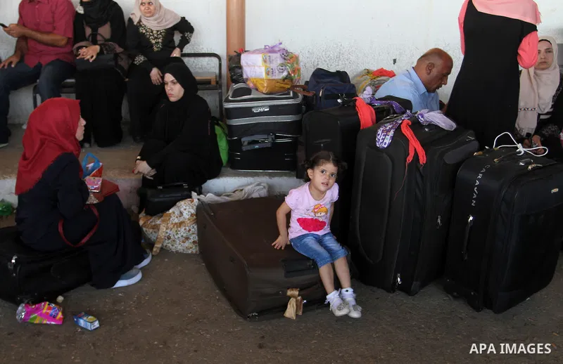 Palestinians wait for travel permits to cross into Egypt through the Rafah border crossing, on September 4, 2016 in the southern Gaza Strip. Egyptian authorities temporarily reopened it both directions for two days in Ga...