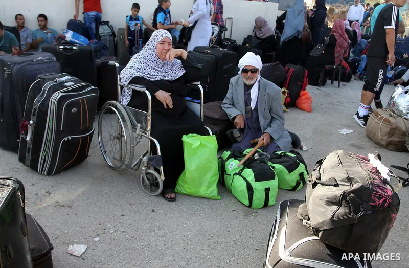 Palestinians wait for travel permits to cross into Egypt through the Rafah border crossing, on September 4, 2016 in the southern Gaza Strip. Egyptian authorities temporarily reopened it both directions for two days in Ga...