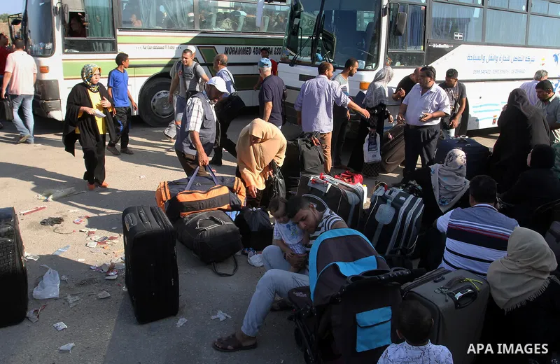 Palestinians wait for travel permits to cross into Egypt through the Rafah border crossing, on September 4, 2016 in the southern Gaza Strip. Egyptian authorities temporarily reopened it both directions for two days in Ga...