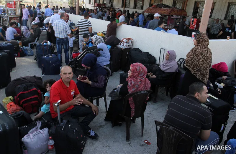 Palestinians wait for travel permits to cross into Egypt through the Rafah border crossing, on September 4, 2016 in the southern Gaza Strip. Egyptian authorities temporarily reopened it both directions for two days in Ga...
