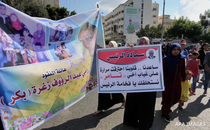 Palestinians hold pictures of their missing relatives during a protest, in front of the headquarters Council of Ministers in Gaza city, on September 6, 2016. Gazans are missing after one of the deadliest migrant shipwrec...