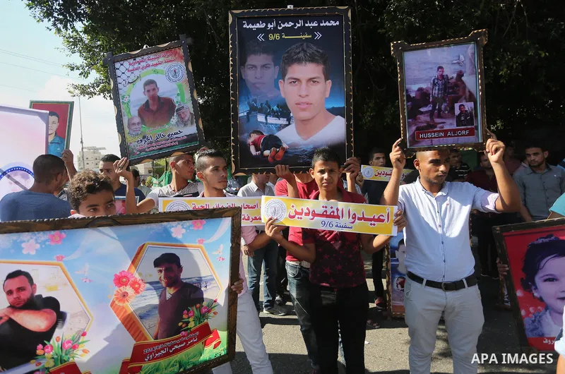 Palestinians hold pictures of their missing relatives during a protest, in front of the headquarters Council of Ministers in Gaza city, on September 6, 2016. Gazans are missing after one of the deadliest migrant shipwrec...