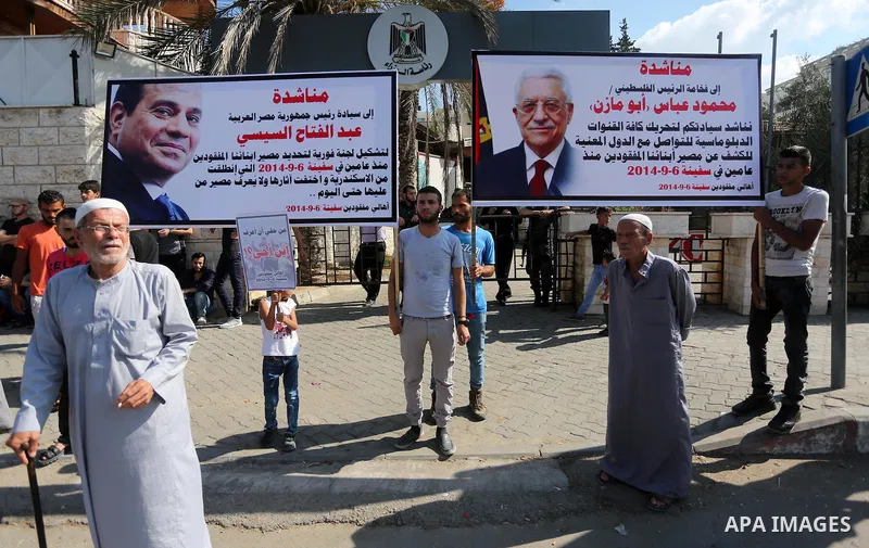 Palestinians hold pictures of their missing relatives during a protest, in front of the headquarters Council of Ministers in Gaza city, on September 6, 2016. Gazans are missing after one of the deadliest migrant shipwrec...