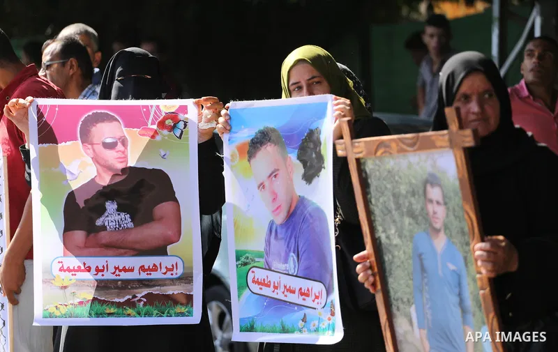 Palestinians hold pictures of their missing relatives during a protest, in front of the headquarters Council of Ministers in Gaza city, on September 6, 2016. Gazans are missing after one of the deadliest migrant shipwrec...