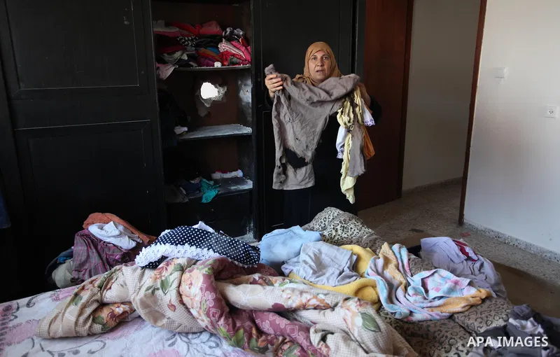 A Palestinian woman inspects her house after it was hit by Israeli tank fire on September 6, 2016 in Beit Hanun in the northern Gaza Strip. Israel's army targeted Hamas posts in the Gaza Strip with tank fire after gunfir...
