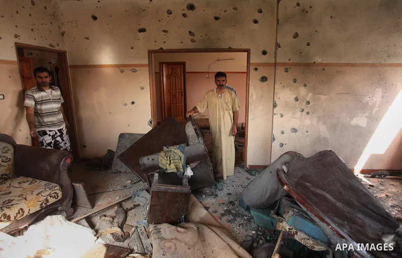 Palestinians from the al-Shanti family check the damage in their house after it was hit by Israeli tank fire on September 6, 2016 in Beit Hanun in the northern Gaza Strip. Israel's army targeted Hamas posts in the Gaza S...