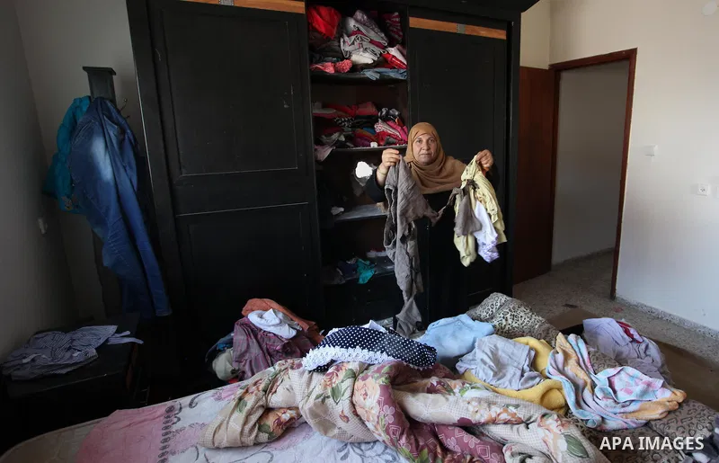 A Palestinian woman inspects her house after it was hit by Israeli tank fire on September 6, 2016 in Beit Hanun in the northern Gaza Strip. Israel's army targeted Hamas posts in the Gaza Strip with tank fire after gunfir...