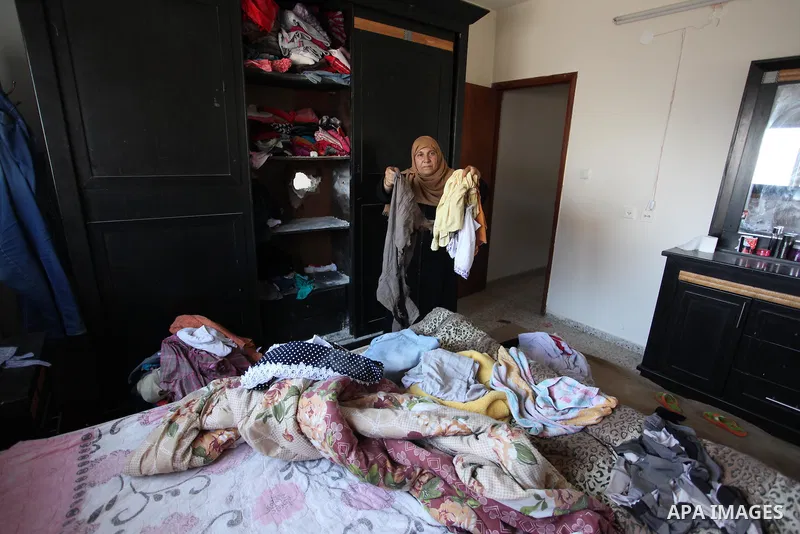 A Palestinian woman inspects her house after it was hit by Israeli tank fire on September 6, 2016 in Beit Hanun in the northern Gaza Strip. Israel's army targeted Hamas posts in the Gaza Strip with tank fire after gunfir...