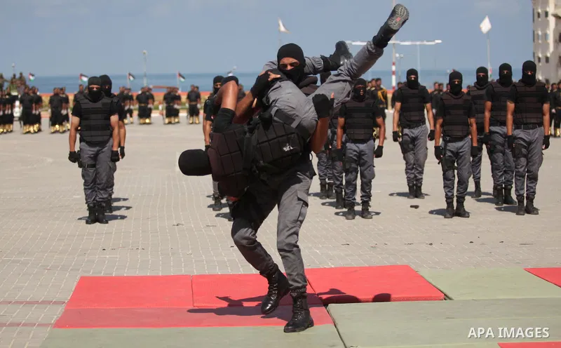 Members of the Palestinian security forces take part in a graduation ceremony in Gaza City on September 6, 2016. Photo by Ashraf Amra