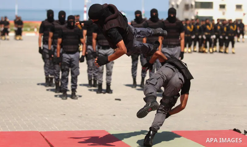 Members of the Palestinian security forces take part in a graduation ceremony in Gaza City on September 6, 2016. Photo by Ashraf Amra