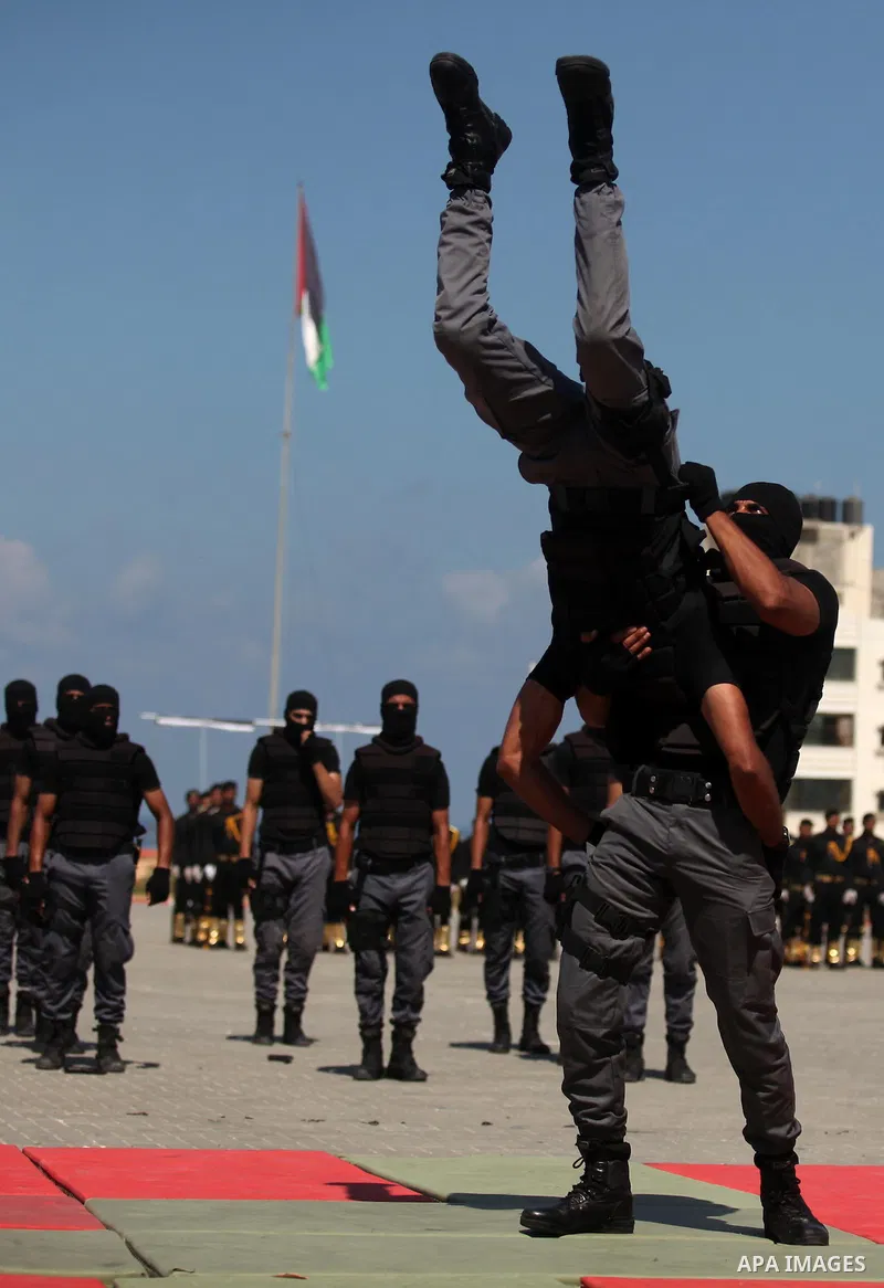 Members of the Palestinian security forces take part in a graduation ceremony in Gaza City on September 6, 2016. Photo by Ashraf Amra