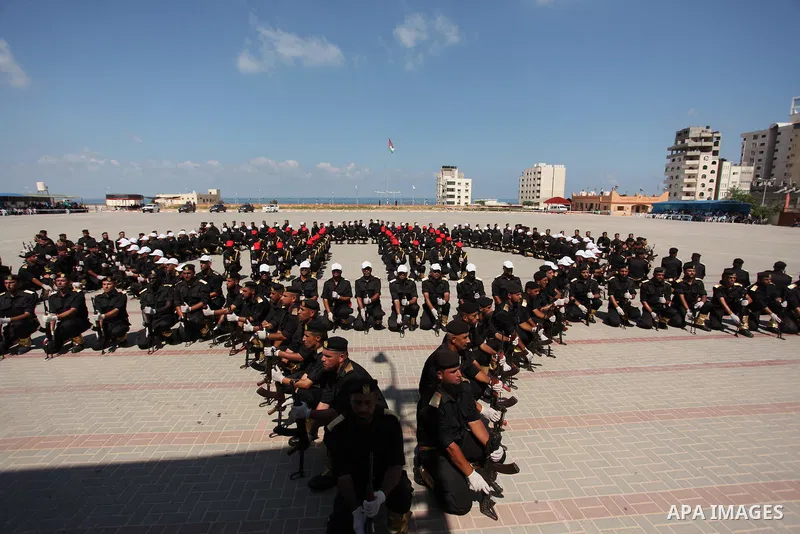Members of the Palestinian security forces take part in a graduation ceremony in Gaza City on September 6, 2016. Photo by Ashraf Amra