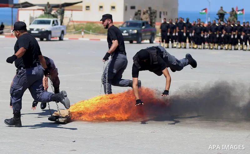 Members of the Palestinian security forces take part in a graduation ceremony in Gaza City on September 6, 2016. Photo by Ashraf Amra