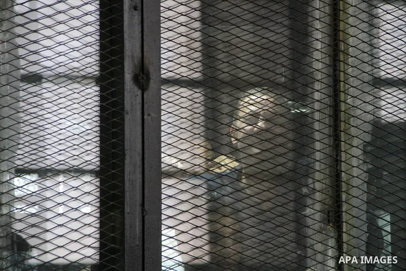 Egyptian Muslim Brotherhood defendants are seen behind bars during their trial, in a case known in media as "Rabaa Operations Room", in Cairo, on Sep. 06, 2016. Photo by Amr Sayed