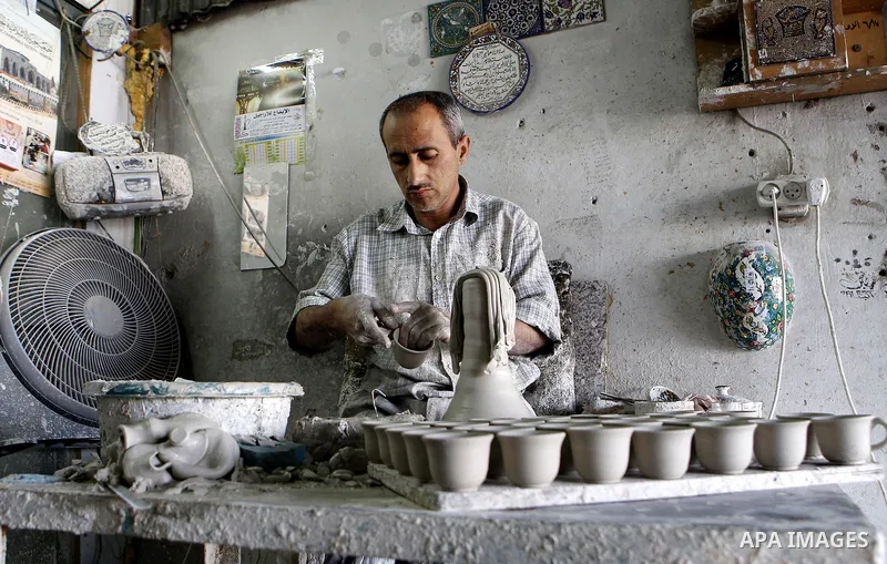 A Palestinian man makes vases from pottery, at his pottery workshop in the West Bank city of Hebron, on Sep. 07, 2016. Hebron, the largest city in the West Bank has been officially awarded the title of World Crafts City,...