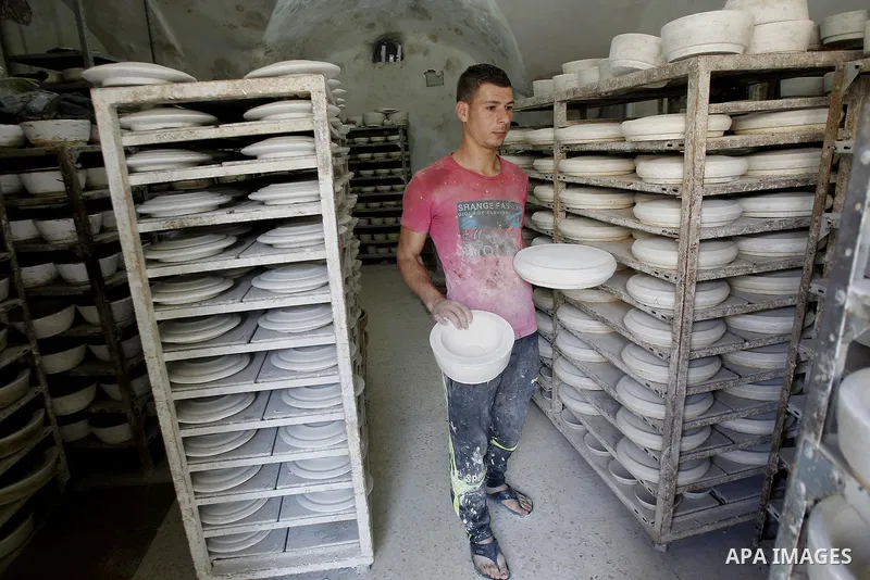 A Palestinian man makes vases from pottery, at his pottery workshop in the West Bank city of Hebron, on Sep. 07, 2016. Hebron, the largest city in the West Bank has been officially awarded the title of World Crafts City,...