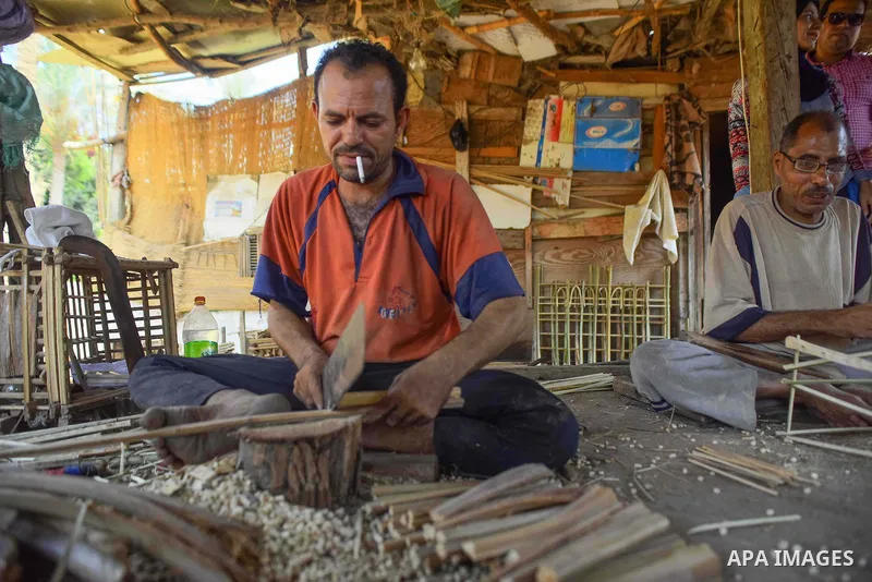 An Egyptian man weaves straw-traditional products, at their workshop, in Cairo, Egypt, on September 7, 2016. Photo by Amr Sayed