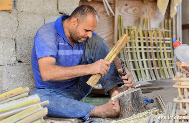An Egyptian man weaves straw-traditional products, at their workshop, in Cairo, Egypt, on September 7, 2016. Photo by Amr Sayed