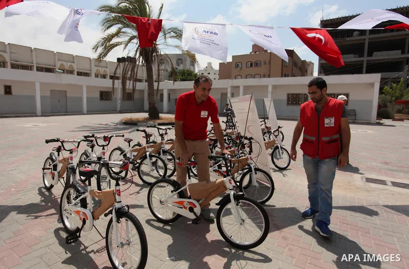 Palestinian children receive bicycles from Turkish aid, ahead of Eid al-Adha in Gaza City, on Sept. 08, 2016. A Turkish delegation arrived in the Gaza Strip on Wednesday ahead of the distribution of Turkish humanitarian...