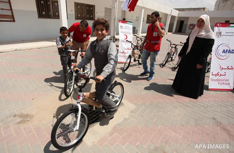 Palestinian children receive bicycles from Turkish aid, ahead of Eid al-Adha in Gaza City, on Sept. 08, 2016. A Turkish delegation arrived in the Gaza Strip on Wednesday ahead of the distribution of Turkish humanitarian...