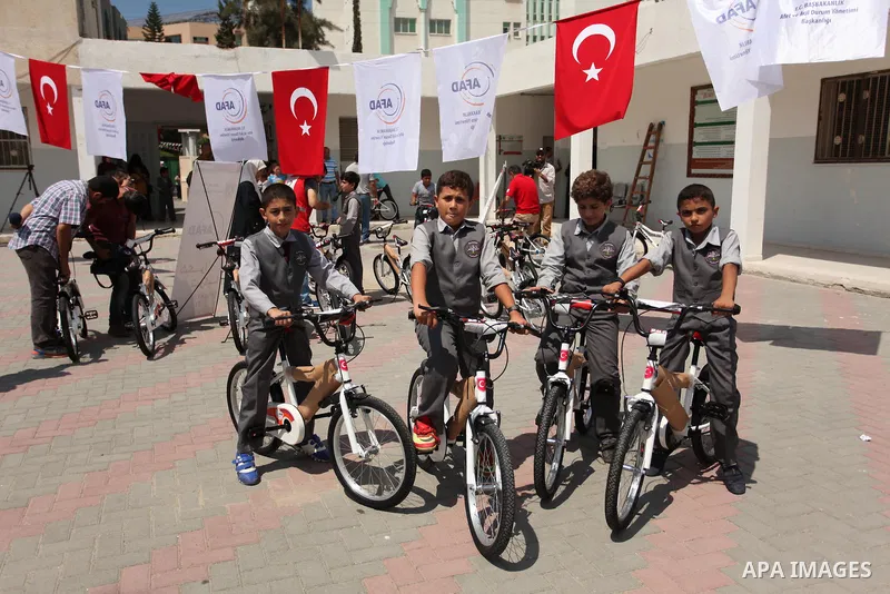 Palestinian children receive bicycles from Turkish aid, ahead of Eid al-Adha in Gaza City, on Sept. 08, 2016. A Turkish delegation arrived in the Gaza Strip on Wednesday ahead of the distribution of Turkish humanitarian...