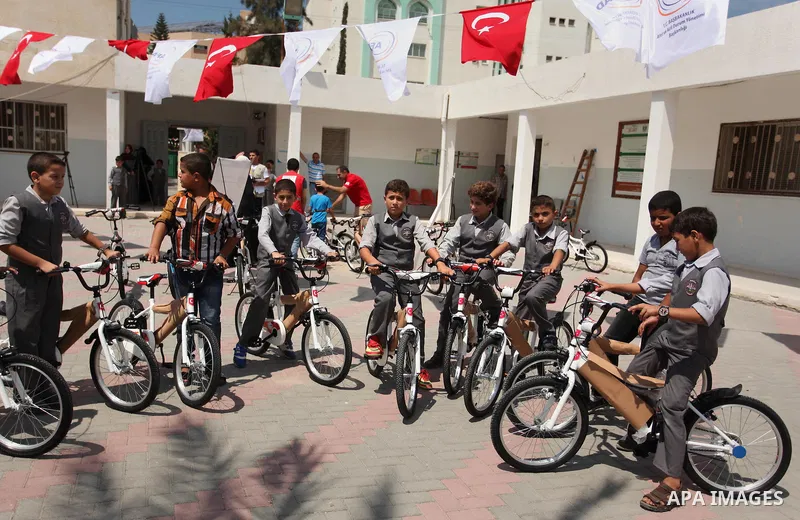 Palestinian children receive bicycles from Turkish aid, ahead of Eid al-Adha in Gaza City, on Sept. 08, 2016. A Turkish delegation arrived in the Gaza Strip on Wednesday ahead of the distribution of Turkish humanitarian...