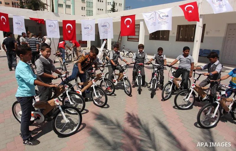 Palestinian children receive bicycles from Turkish aid, ahead of Eid al-Adha in Gaza City, on Sept. 08, 2016. A Turkish delegation arrived in the Gaza Strip on Wednesday ahead of the distribution of Turkish humanitarian...