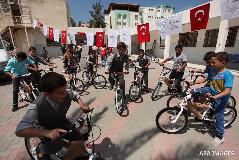 Palestinian children receive bicycles from Turkish aid, ahead of Eid al-Adha in Gaza City, on Sept. 08, 2016. A Turkish delegation arrived in the Gaza Strip on Wednesday ahead of the distribution of Turkish humanitarian...
