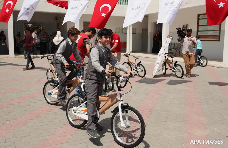 Palestinian children receive bicycles from Turkish aid, ahead of Eid al-Adha in Gaza City, on Sept. 08, 2016. A Turkish delegation arrived in the Gaza Strip on Wednesday ahead of the distribution of Turkish humanitarian...