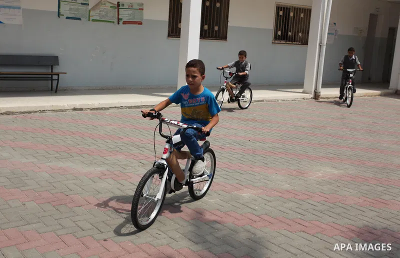 Palestinian children receive bicycles from Turkish aid, ahead of Eid al-Adha in Gaza City, on Sept. 08, 2016. A Turkish delegation arrived in the Gaza Strip on Wednesday ahead of the distribution of Turkish humanitarian...