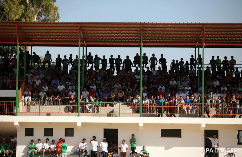 Palestinian spectators watch Super Cup soccer match between Shabab Khan Younis and Khadamat Rafah, at Yarmouk Stadium in Gaza city, on Sep. 09, 2016. Photo by Ashraf Amra