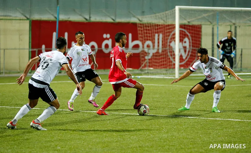 Players of Hebron's Ahly al-Khalil football club and players of Hebron's Shabab al-Khalil club compete during Super Cup soccer match, in the West Bank city of Hebron, on Sep. 09, 2016. Photo by Wisam Hashlamoun