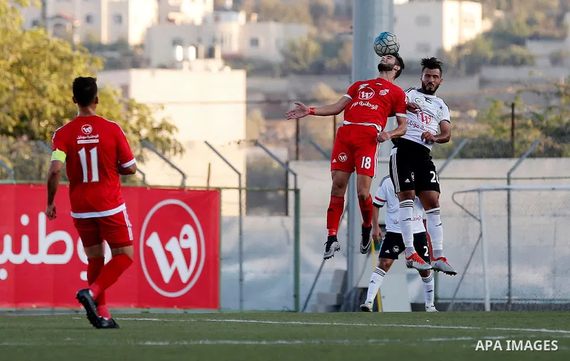 Players of Hebron's Ahly al-Khalil football club and players of Hebron's Shabab al-Khalil club compete during Super Cup soccer match, in the West Bank city of Hebron, on Sep. 09, 2016. Photo by Wisam Hashlamoun