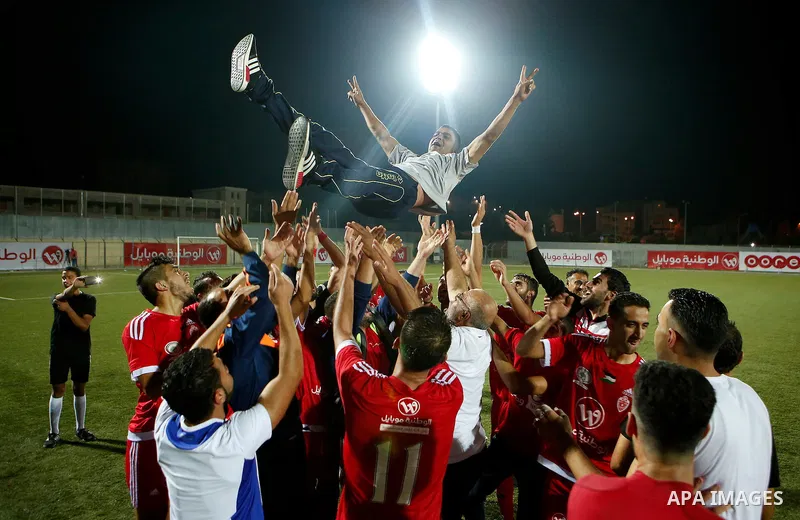 Players of Hebron's Ahly al-Khalil football club celebrate after beating Hebron's Shabab al-Khalil during Super Cup soccer match, in the West Bank city of Hebron, on Sep. 09, 2016. Photo by Wisam Hashlamoun