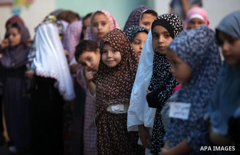 Palestinian children gather around a makeshift cube representing the holy Kaaba, in Gaza, on Sept. 10, 2016, as part of training children how to perform Hajj pilgrimage. Muslims from around the world flood Saudi city of...