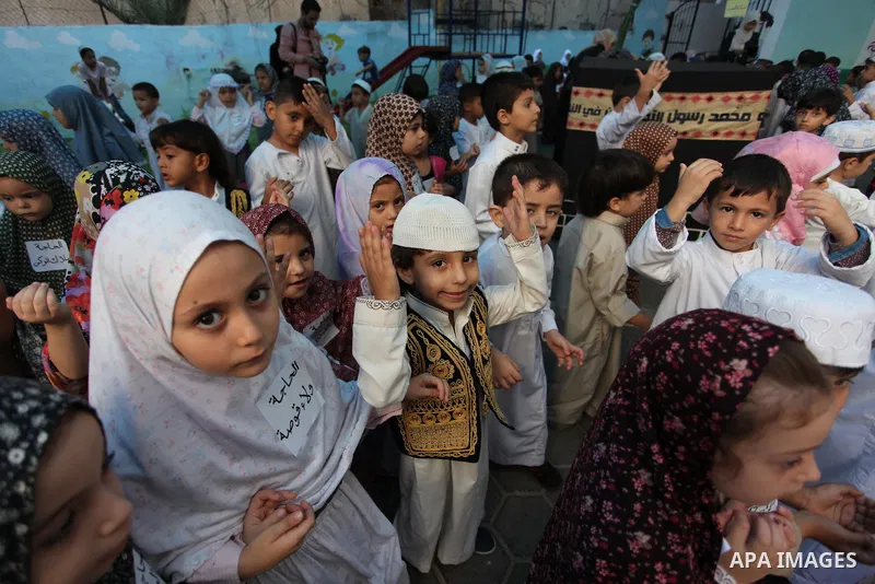 Palestinian children gather around a makeshift cube representing the holy Kaaba, in Gaza, on Sept. 10, 2016, as part of training children how to perform Hajj pilgrimage. Muslims from around the world flood Saudi city of...