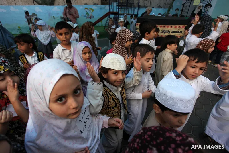 Palestinian children gather around a makeshift cube representing the holy Kaaba, in Gaza, on Sept. 10, 2016, as part of training children how to perform Hajj pilgrimage. Muslims from around the world flood Saudi city of...