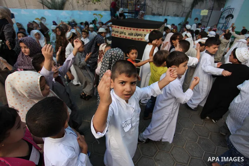 Palestinian children gather around a makeshift cube representing the holy Kaaba, in Gaza, on Sept. 10, 2016, as part of training children how to perform Hajj pilgrimage. Muslims from around the world flood Saudi city of...