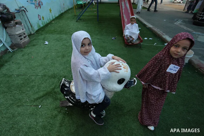 Palestinian children gather around a makeshift cube representing the holy Kaaba, in Gaza, on Sept. 10, 2016, as part of training children how to perform Hajj pilgrimage. Muslims from around the world flood Saudi city of...