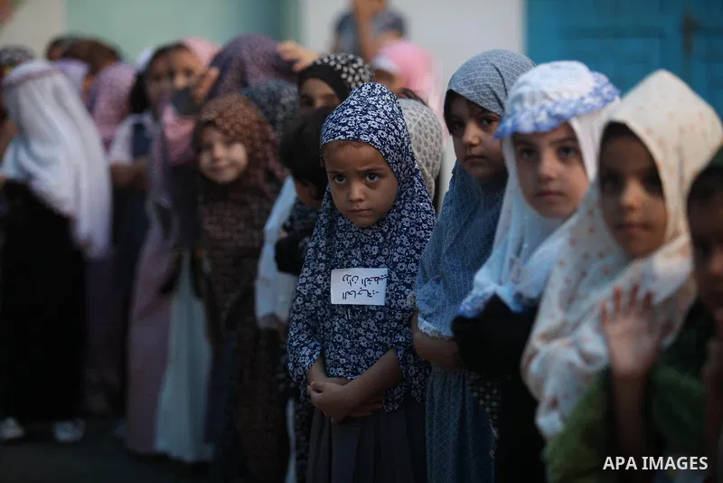 Palestinian children gather around a makeshift cube representing the holy Kaaba, in Gaza, on Sept. 10, 2016, as part of training children how to perform Hajj pilgrimage. Muslims from around the world flood Saudi city of...