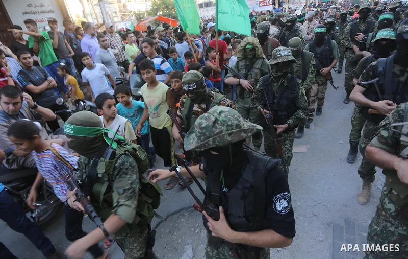 Palestinian militants of the Ezzedine al-Qassam Brigades, Hamas' armed wing, take part in a military parade to celebrate the Muslim festival of Eid al-Adha, in Gaza city, on Sep. 10, 2016. Photo by Mohammed Asad