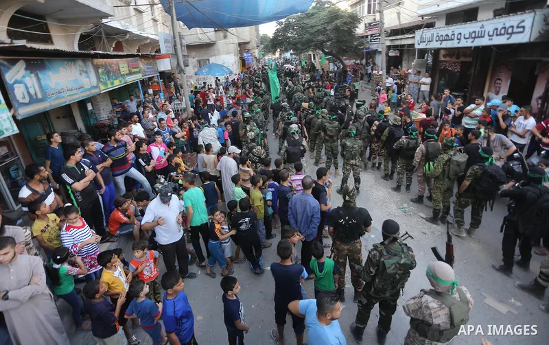 Palestinian militants of the Ezzedine al-Qassam Brigades, Hamas' armed wing, take part in a military parade to celebrate the Muslim festival of Eid al-Adha, in Gaza city, on Sep. 10, 2016. Photo by Mohammed Asad
