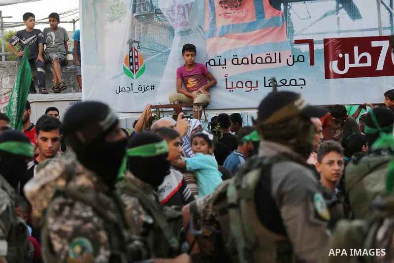 Palestinian militants of the Ezzedine al-Qassam Brigades, Hamas' armed wing, take part in a military parade to celebrate the Muslim festival of Eid al-Adha, in Gaza city, on Sep. 10, 2016. Photo by Mohammed Asad