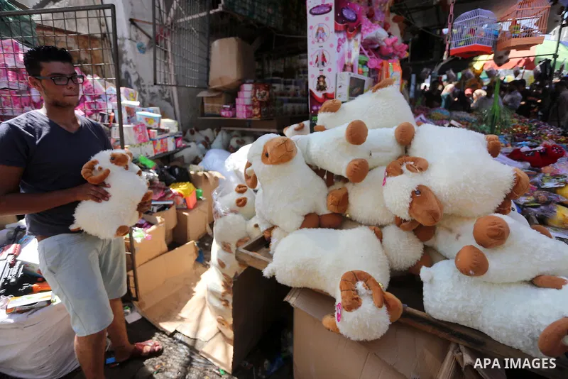 A Palestinian vendor display toys, ahead of the Eid al-Adha festival, at a market in Gaza city, on Sep. 11, 2016. Photo by Mohammed Asad