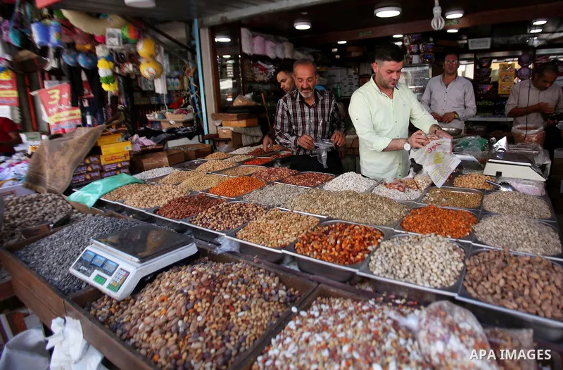 A Palestinian vendor sells nuts at a market ahead of the Eid al-Adha festival in the West Bank city of Nablus on Sept. 11, 2016. Photo by Nedal Eshtayah