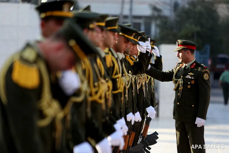 Palestinian honor guards take position before Palestinian President Mahmoud Abbas arrives to lay a wreath on the grave of late Palestinian leader Yasser Arafat on the first day of Eid al-Adha, or feast of the sacrifice,...