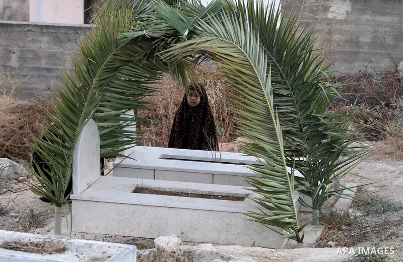 A Palestinian girl visits the grave of her relative at a cemetery on the first day of of Eid al-Adha, or feast of the sacrifice, in the West Bank city of Nablus, on Sep. 12, 2016. Muslims around the world are celebrating...